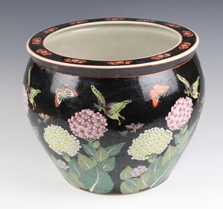 An antique style Chinese black ground jardiniere decorated with insects and flowers, the interior with carp 36cm 