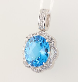 A 14ct white gold oval topaz and diamond pendant, the centre stone 12mm x 15mm, the diamonds approx. 0.5ct, 28mm, 7.2 grams 