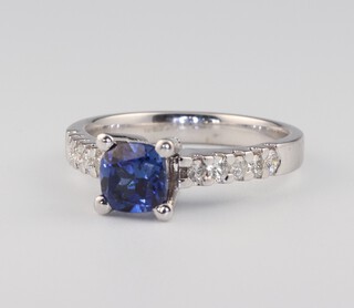 An 18ct white gold square sapphire and diamond ring, the sapphire approx. 0.75ct, the brilliant cut diamonds 0.03ct, size O, 4.9 grams 