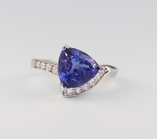 A 14ct white gold triangular cut tanzanite and diamond ring, the centre stone 3.1ct, the brilliant cut diamonds 0.2ct, 4.1 grams, size M 1/2