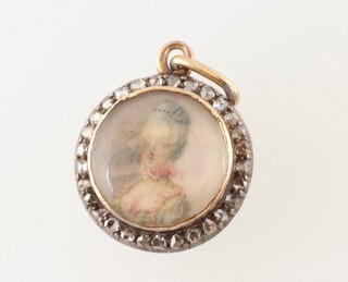 A 19th Century circular miniature of a lady set in a circular diamond set mount 15mm