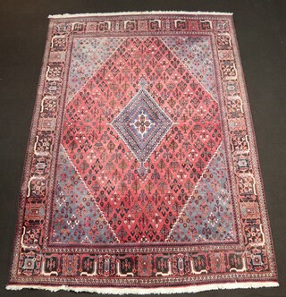 A red, white and blue ground North Persian carpet with diamond medallion to the centre 337cm x 244cm 