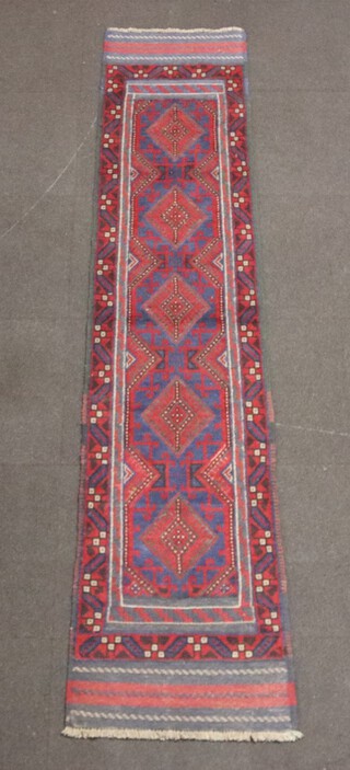 A red and blue ground Meshwani runner with 5 diamonds to the centre 255cm x 52cm 