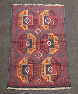 A black, red and white ground Belouche rug with 6 square medallions to the side 114cm x 87cm 