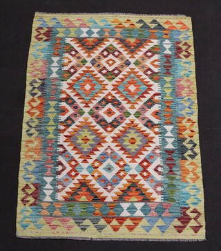 A white, turquoise and brown ground Chobi Kilim rug with overall geometric design 157cm x 107cm 