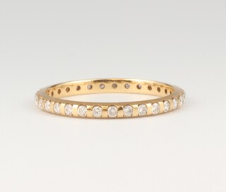 A 9ct yellow gold diamond set eternity ring, 0.5ct, size O 1/2, 1.8 grams