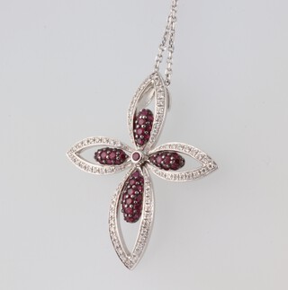 An 18ct yellow gold ruby and diamond floral pendant 35mm by 30mm, 4.7 grams on an 18ct white gold chain 2.8 grams 60cm 