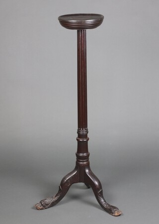 A 19th Century turned mahogany torchere raised on a turned and fluted column with carved dolphin tripod supports 119cm h x 27cm diam. 