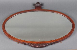 An Edwardian oval bevelled plate wall mirror contained in an inlaid mahogany frame surmounted by a lidded urn 92cm h x 99cm w