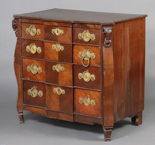 A 20th Century Continental veneered mahogany inverted breakfront commode fitted 4 drawers with rams mask decoration to the sides and with gilt oval plate drop handles 86cm h x 92cm w x 57cm d 