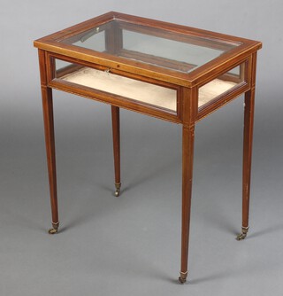 An Edwardian rectangular inlaid mahogany bijouterie table with hinged lid, raised on square tapered supports ending in brass caps and casters 72cm h x 60cm w x 40cm d 