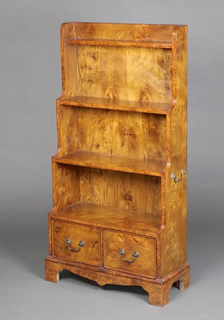 A Georgian style figured walnut waterfall bookcase fitted 4 shelves with brass drop handles to the sides, the base fitted 2 drawers, raised on bracket feet 122cm h x 61cm w x 25cm d 