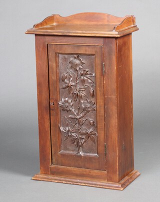 An Edwardian carved walnut cabinet with 3/4 gallery, fitted shelves enclosed by deep carved panelled door 76cm h x 46cm w x 24cm d 