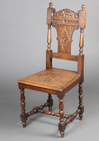 A Victorian carved oak hall chair with solid back and seat, raised on turned and block supports with H framed stretcher 103cm h x 47cm w x 44cm d (seat 25cm x 28cm) 