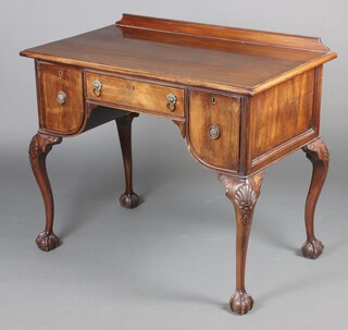 An  Edwardian Georgian style mahogany dressing table with raised back, fitted a drawer, flanked by cupboards enclosed by arched panelled doors, raised on cabriole ball and claw supports 85cm h x 101cm w x 51cm d 