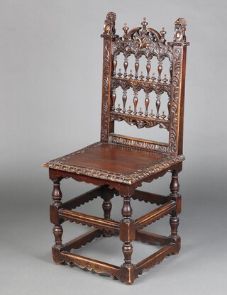 A Victorian heavily carved Gothic oak ladder back hall chair, the crest carved a figure of St George slaying the dragon, with solid seat, raised on turned and block supports with box framed stretcher  104cm h x 46cm w x 42cm d (seat 28cm x 25cm) 