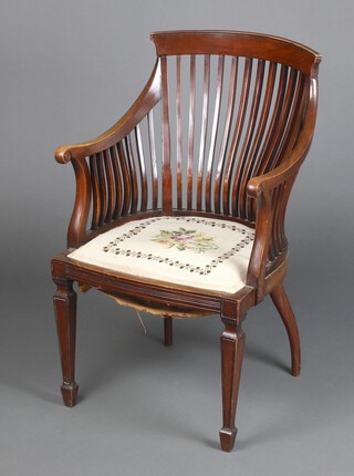 An Edwardian mahogany stick and rail back armchair with upholstered seat, raised on square tapered supports, spade feet 88cm h x 55cm w x 43cm d (seat 26cm x 26cm) 