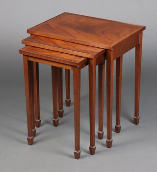 A nest of 3 Georgian style crossbanded mahogany interfitting coffee tables, raised on square tapered supports, ending in spade feet 60cm h x 53cm w x 38cm d 