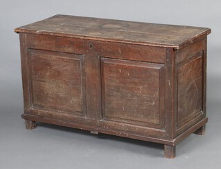 An 18th Century elm coffer with hinged lid and iron lock, raised on square supports 71cm h x 119cm w x 51cm d 