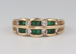 A yellow gold, testing as 14ct, emerald and diamond ring set with 12 princess cut emeralds 0.60ct and 8 brilliant cut diamonds 0.50ct, size M 1/2, 4.8 grams