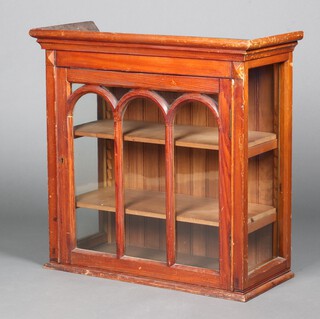 A Victorian pitched pine hanging cabinet with moulded cornice, interior fitted 2 shelves enclosed by arched panelled astragal glazed doors 75cm h x 76cm w x 33cm d 