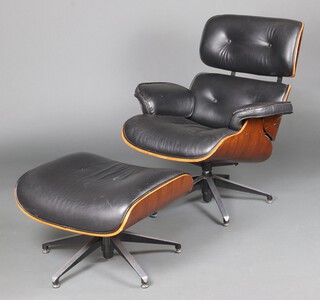 In the manner of Eames, a revolving chair and footstool upholstered in black leather 