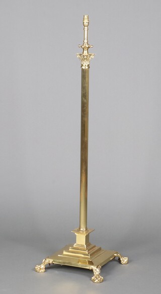 A reeded brass adjustable standard lamp with Corinthian column capital and stepped base 130cm x 39cm 