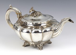 A Victorian silver melon shaped teapot with floral finial and S scroll handle on scroll legs London 1837, maker Samuel Hayne and Dudley Cater, gross weight 730 grams with ivory resistors, Ivory Exemption Certificate No. U2D8FE6T