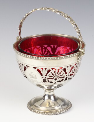 A Victorian silver swing handled basket with pierced decoration and engraved armorial, London 1863, maker Edward and John Barnard, 222 grams, with later red liner 