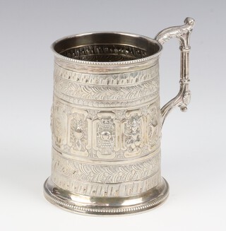 An Indian repousse silver mug decorated with figures and animals and rustic handle 9.5cm, 164 grams 