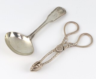 A pair of Victorian silver sugar nips London 1877 and a George IV caddy spoon with engraved monogram London 1825, 34 grams 