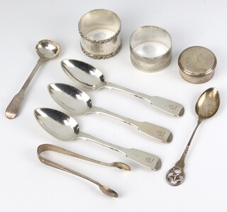 A circular silver patch box, rubbed marks, 2 napkin rings, a pair of sugar nips and 5 spoons 208 grams