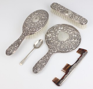 A Victorian style repousse silver mounted dressing table set comprising hand mirror, clothes brush, hair brush and comb (a/f), together with a teaspoon Birmingham 1952 