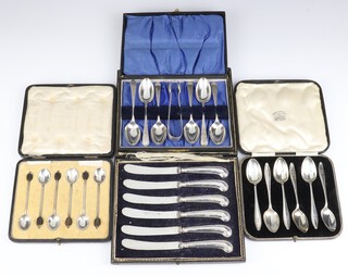 Six silver teaspoons and sugar nips Sheffield 1911, 6 teaspoons Sheffield 1937, 6 coffee spoons with bean ends Birmingham 1920 and a case set of silver handled butter knives, weighable silver gross including bean ends 258 grams 