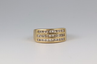 A yellow gold, testing as 9ct, 3 row channel set diamond ring, approx. 0.30ct, size L, 5.6 grams 