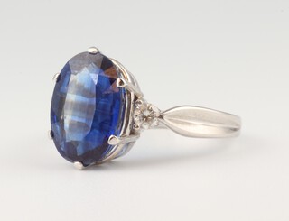 An 18ct white gold oval "sapphire" and diamond ring, the centre stone 3ct, the diamonds 0.10ct, size P 1/2, 6.8 grams 