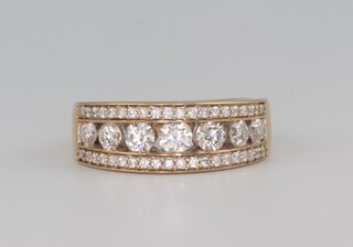 A yellow gold, testing as 14ct, 7 stone diamond ring flanked by brilliant cut diamonds 0.24ct, size L 1/2 