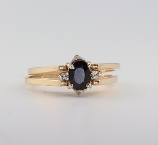 A 14ct yellow gold sapphire and diamond reversible ring, having an oval cut sapphire approx. 0.6ct and 11 brilliant cut diamonds 0.1ct, size N 1/2,  4.5 grams 