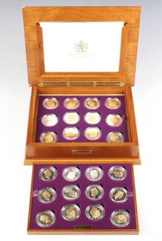 A Royal Mint Queen Elizabeth II Golden Jubilee silver coin collection comprising 24 commemorative medallions, 687.80 grams, in plastic cases with 2 tier mahogany finish box 