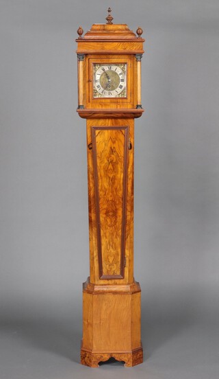 A longcase timepiece with 19cm brass dial, silvered chapter ring and Roman numerals, contained in a figured walnut case with sliding hood, complete with pendulum and key 176cm h x 32cm w x 21cm d 