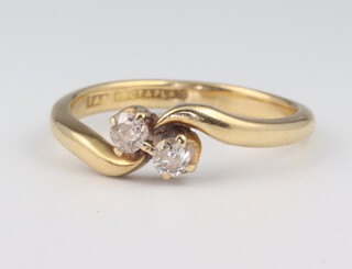 An 18ct yellow gold 2 stone diamond crossover ring, approx. 0.30ct,  size R, 4.3 grams