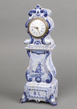 A 19th Century Continental timepiece with enamelled dial, Roman numerals, contained in a Delft blue and white case decorated a windmill 27cm h x 9cm w x 7cm d 