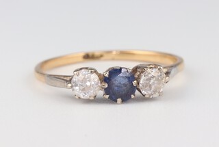 An 18ct yellow gold ring set 2 diamonds and a sapphire, the diamonds 0.3ct, the sapphire 0.2ct, size L, 1.5 grams  