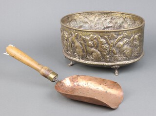 A metal (previously silver plated) oval embossed bowl decorated standing rabbits and carrots raised on shaped supports 15cm x 31cm x 32cm together with a copper scoop with turned wooden handle 