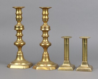 A pair of Victorian brass candlesticks with ejectors 28cm and 1 other pair of 19th Century brass candlesticks 15cm on square bases 