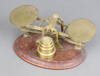 A set of brass letter scales complete with weights 