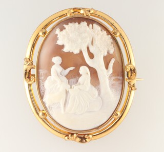 A Victorian gold plated oval Victorian cameo brooch with figures beneath a tree 65mm 