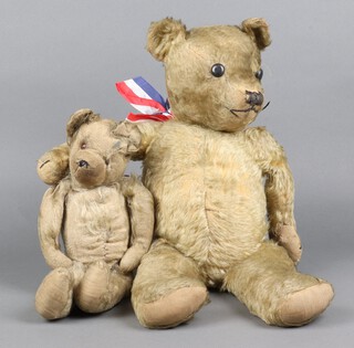 A mohair straw filled teddy bear with articulated limbs 32cm (having a non working growler and in worn condition) and 1 other with button eyes and articulated limbs 50cm (right pad repaired) 