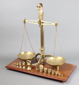 A set of C Stevens and Sons brass scales on a mahogany base, complete with 8 graduated ounce bell weights and 7 graduated gram weights 63cm h x 61cm w x 30cm d  