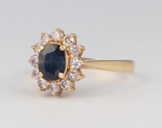 A yellow gold, testing as 18ct, oval sapphire and diamond cluster ring, the centre stone 1ct, the diamonds approx 0.36ct (12), size P, 4 grams 